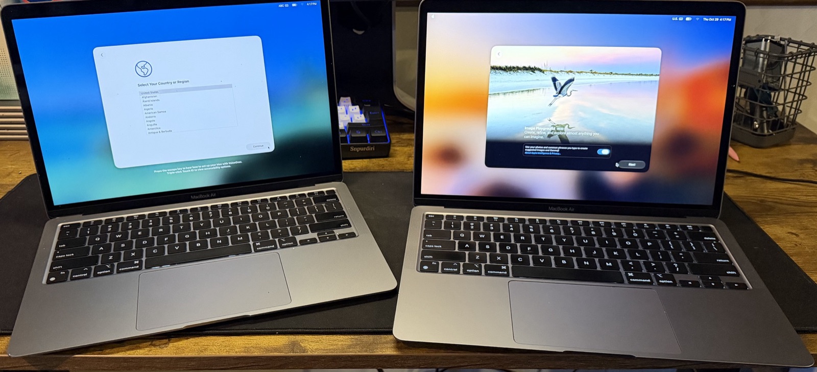 Two M1 MacBook Airs open and powered on