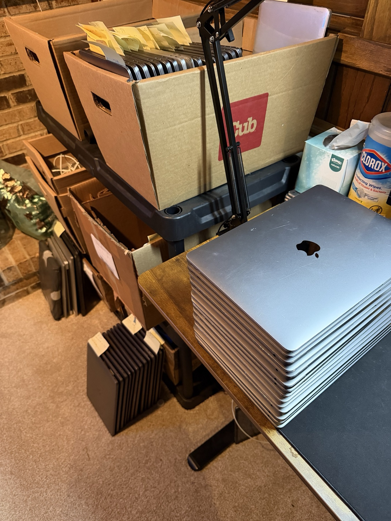 Boxes of MacBooks behind the batch
